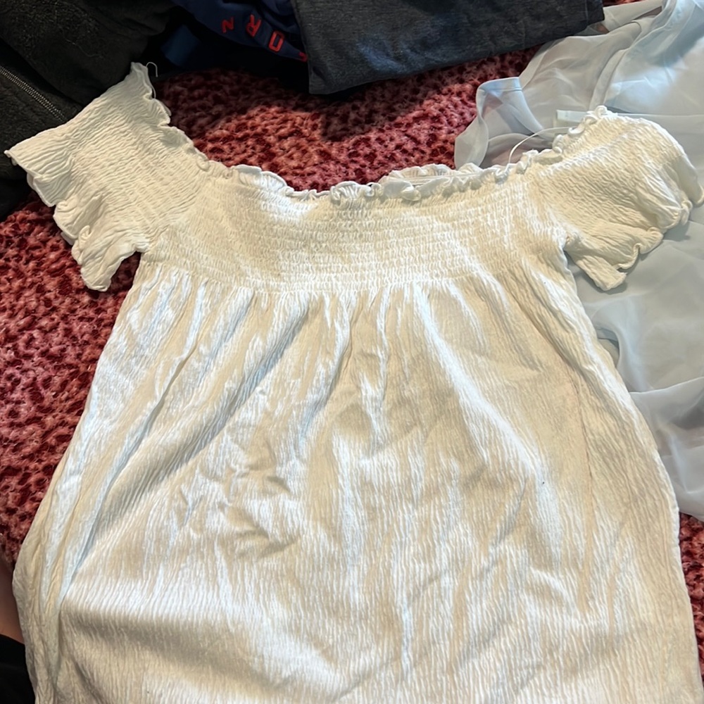 Woman’s white off the shoulder shirt